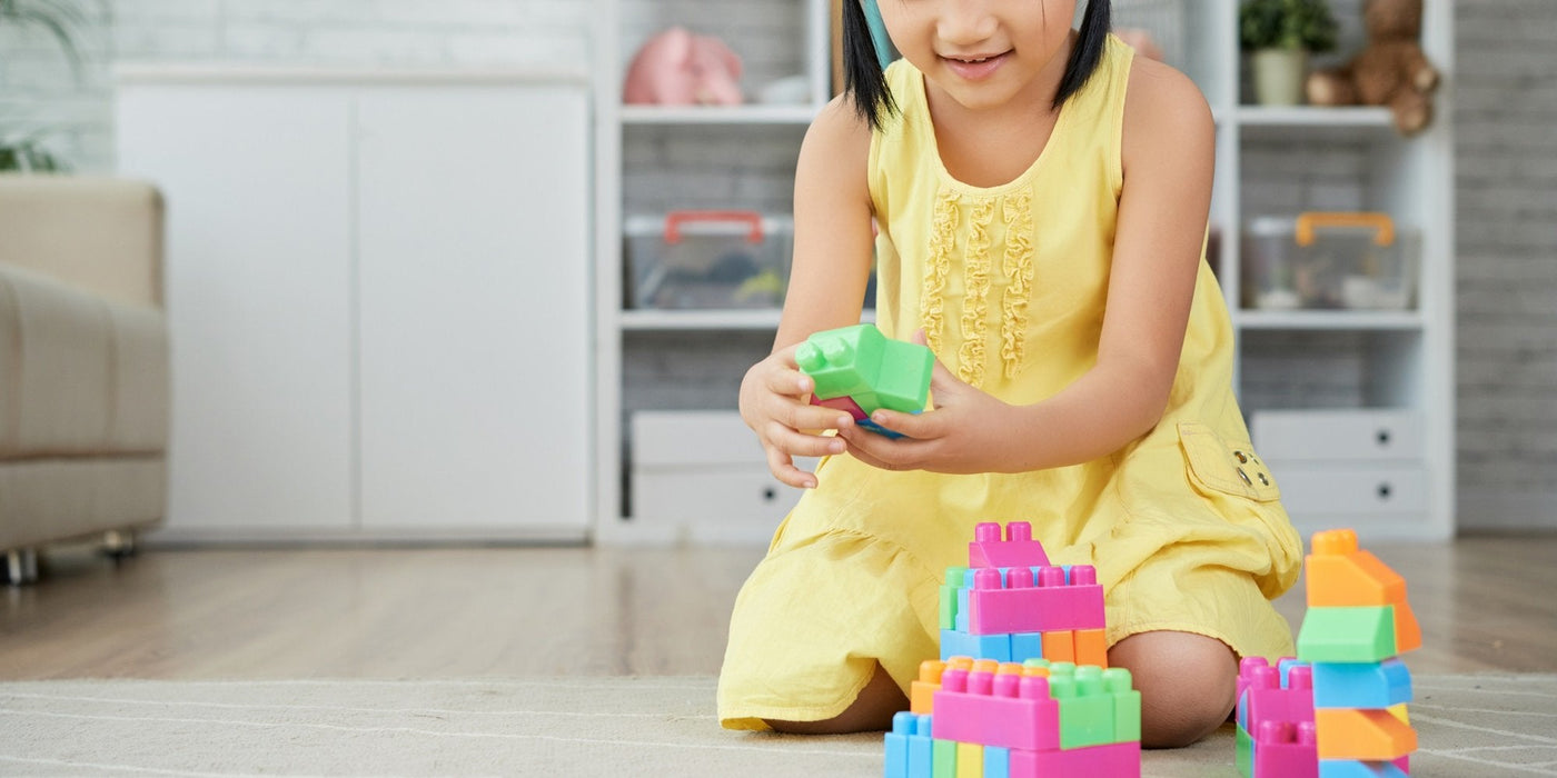 a girsl is playing with building block construction toys